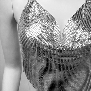 Close-up of metallic silver sequin mesh fabric on a sexy party top for women