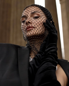 Detail of sparkling rhinestone mesh veil paired with elegant black long velvet gloves