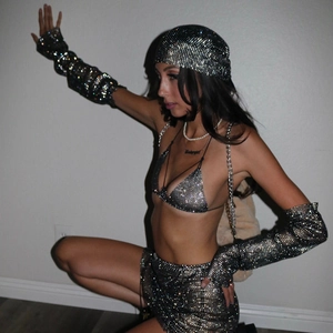 Detailed view of shimmering rhinestone fishnet headscarf with matching glitter accessories