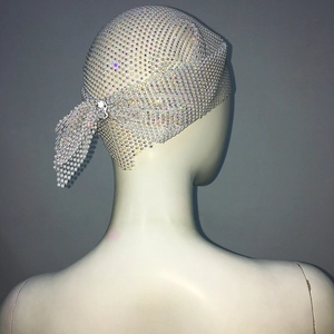 Detailed view of white mesh rhinestone headpiece with sparkling crystals for parties