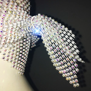 Macro shot of white beaded fishnet headpiece with sparkling iridescent rhinestones