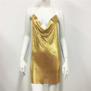 Detailed view of gold sequin dress with deep V-neck and delicate metallic chain straps