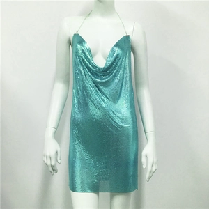 Detail of teal metal mesh sequin mini dress with deep V-neckline on a mannequin