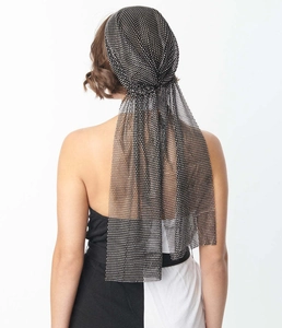 Detail of black mesh headpiece with sparkling rhinestones and elegant long flowing tassels