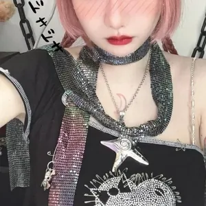 Detail of metallic sequin scarf featuring a star pendant and unique mesh texture