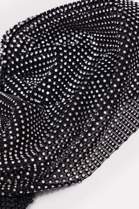 Macro shot of sparkling rhinestones on black mesh fabric for elastic fishnet cap decoration