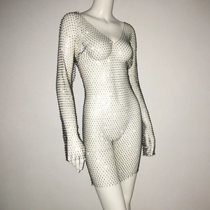 Detail of sheer fishnet dress featuring sparkly rhinestones and deep V-neckline