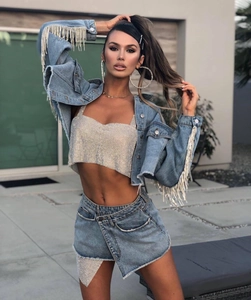 Detailed view of rhinestone fringe on denim jacket with sparkling silver sequin top
