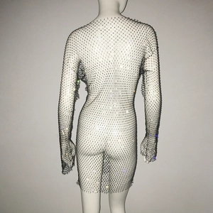 Detailed view of fishnet dress with sparkling rhinestones and long sleeves for party wear