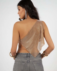 Detail of gold metal mesh one-shoulder top with chain back and shimmering rhinestone texture