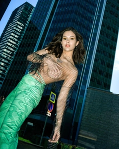 Close-up of mesh long sleeve top with sparkling rhinestones and bold printed pants