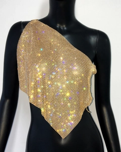 Close-up of golden mesh shoulder top with sparkling rhinestones for music festivals