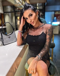 Detail of black mesh dress featuring sparkling silver rhinestones and two-piece layered design