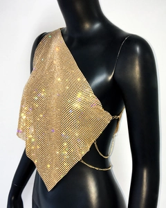 Detail of gold rhinestone mesh top with metal chains and asymmetric halter neckline