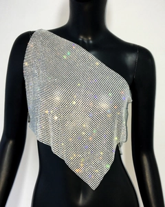 Detail of silver rhinestone mesh chain top featuring asymmetrical one-shoulder design