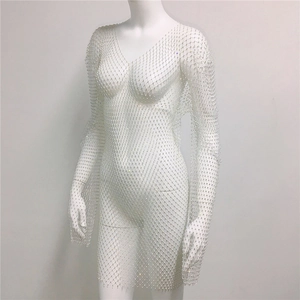 Detailed view of white rhinestone mesh fabric with sparkly crystals on sexy V-neck dress