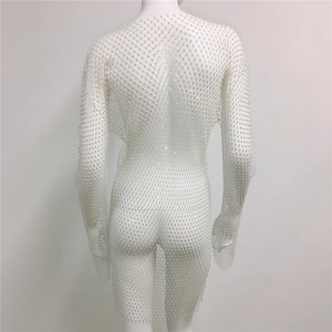 Detail of white mesh dress with long sleeves and sparkling rhinestones for party wear