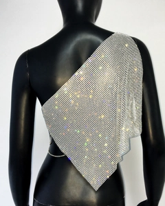 Detail of silver rhinestone mesh one-shoulder top with chain link and asymmetric hem