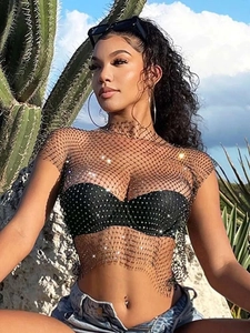 Sexy black fishnet top with sparkling rhinestones worn by a model in a desert setting