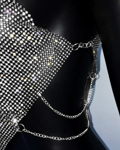 Detailed macro view of silver metallic mesh top with sparkling rhinestones on black mannequin