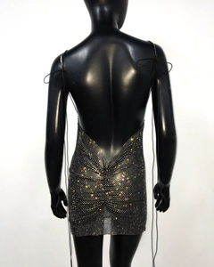 Macro shot of backless black mini dress featuring rhinestone mesh and thin straps