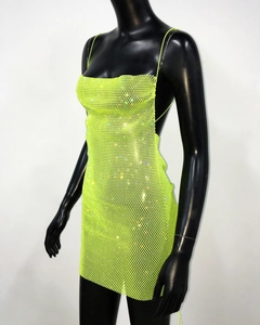 Detail of neon green sequin mini dress featuring metallic mesh and thin straps