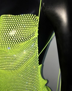 Detail of neon green mesh dress with sparkling rhinestones for party and club wear