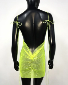 Macro detail of fluorescent yellow mesh mini dress with sparkling rhinestones and tie-back