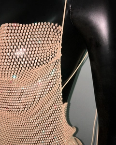 Close-up of sparkling crystals on sheer mesh fabric and delicate shoulder straps