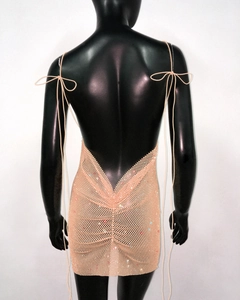 Detail of the open back design on a sequined mesh mini dress with thin straps