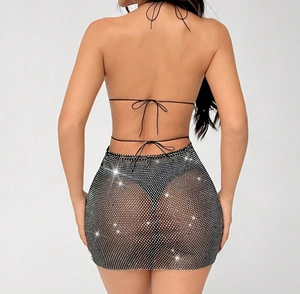 Close-up of black mesh mini dress featuring sparkly rhinestones and criss-cross back straps