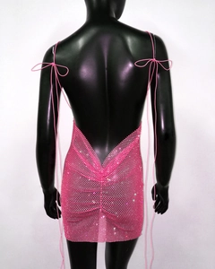 Detail of pink rhinestone mesh mini dress featuring a backless design and thin straps