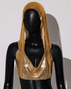 Close-up of gold metal sequin hooded top with shimmering mesh texture for party wear