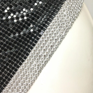 Detailed macro view of black metal sequins and sparkling rhinestone trim on top