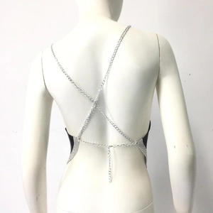 Detail of sexy backless top with black metal mesh and silver crisscross chain straps