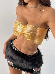 Golden sequin crop top with chain straps and metallic fringe for music festivals
