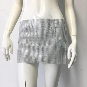 Detailed close-up of shiny silver sequin mini skirt with sparkling rhinestone mesh texture