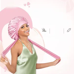 Close-up of pink satin sleep cap with long elastic ribbon tie for hair protection