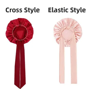 Detail of satin sleeping bonnets in criss-cross and elastic styles with wide silk ribbons