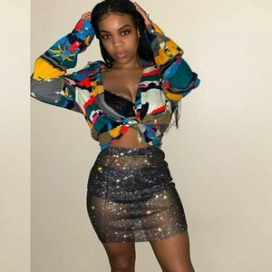 Detailed view of black sequined mesh skirt with colorful reflective shimmering sparkles