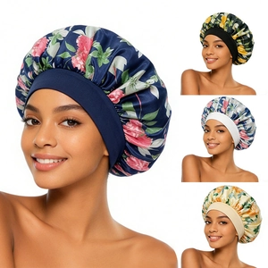 Detail view of four satin floral sleep caps in navy, black, silver, and beige with elastic bands