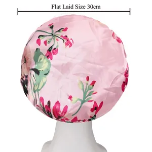 Pink floral satin sleep cap on mannequin head with 30cm flat size measurement