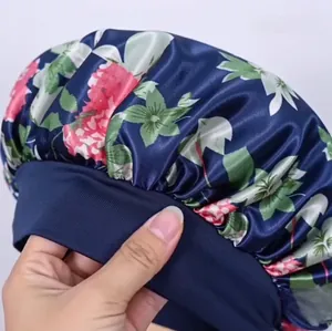 Macro detail showing high-elastic band and floral satin fabric of the sleep bonnet