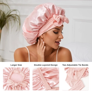 Detail of pink satin sleep cap featuring a double-layered design and adjustable tie bands