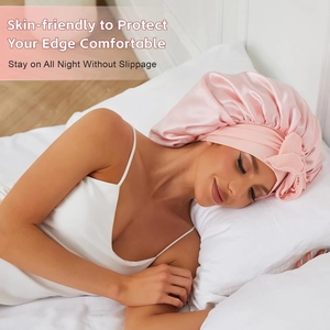 Pink satin hair bonnet with wide elastic band and bow tie for sleeping and hair care