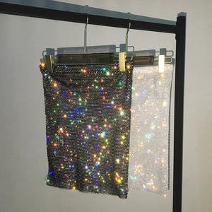 Detail shot of sparkling rhinestone fishnet mini skirts in black and white styles