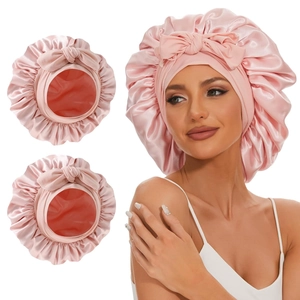 Pink satin elastic sleep cap with decorative bow and wide band for hair protection