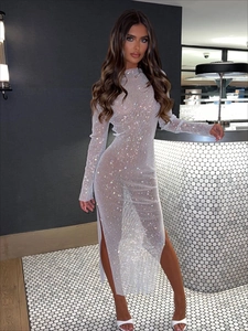 Close-up of sparkling rhinestones on semi-sheer mesh long sleeve dress with side slit