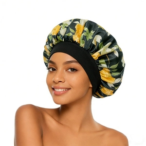 Detailed macro view of vibrant yellow floral print on smooth satin sleep cap with black band