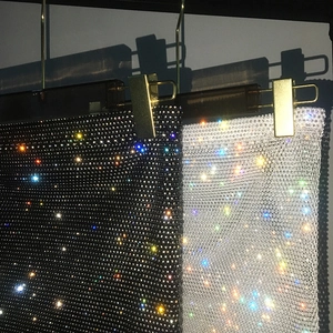 Detail of high-density rhinestone mesh fabric in black and silver for party skirts